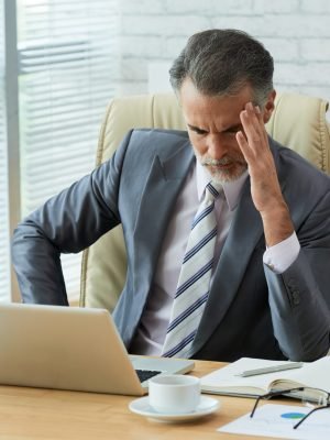 businessman-concentrated-computer-data-touching-his-head-headache-scaled.jpg